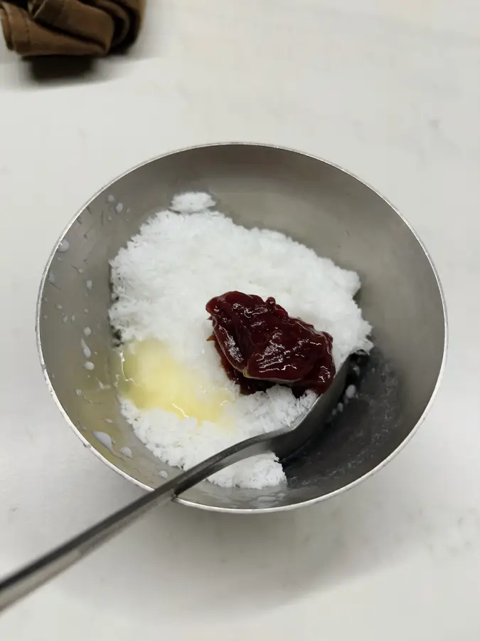 Bingsu (ghiaccio tritato) in una ciotola di acciaio inossidabile guarnito con pasta di fagioli rossi e latte condensato